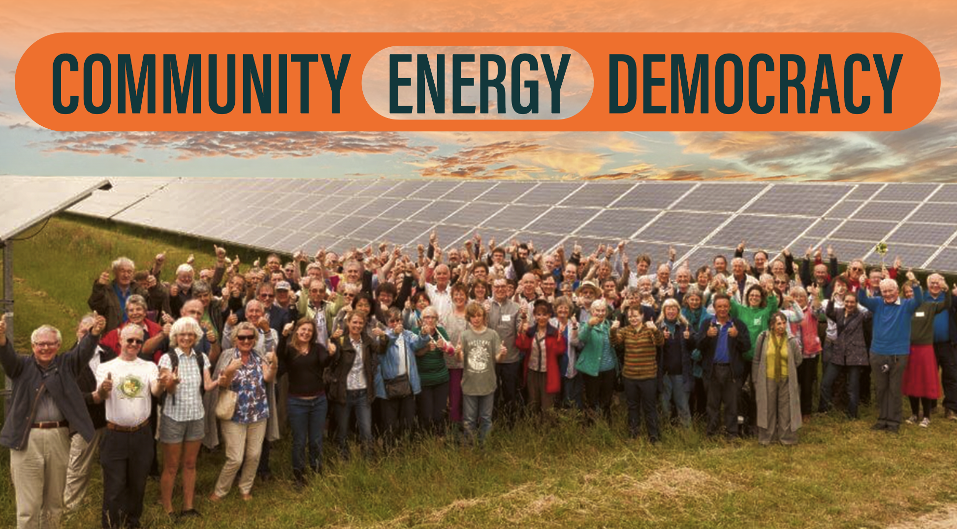 Text on top says: Community Energy Democracy with a community cheering. Behind them is a lager solar farm and with beautiful sunset in the background.